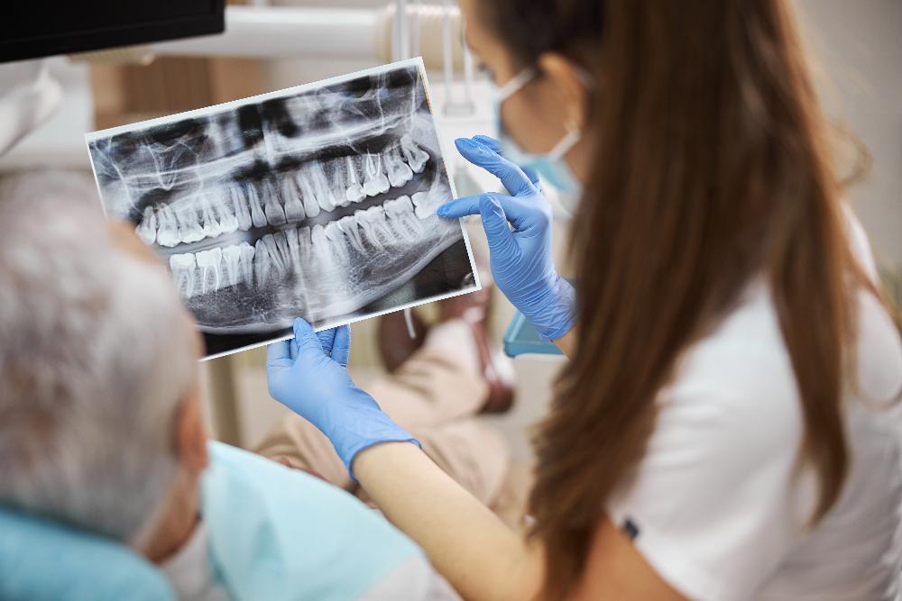 dentist looking at dental x-ray | tooth extraction beaverton or