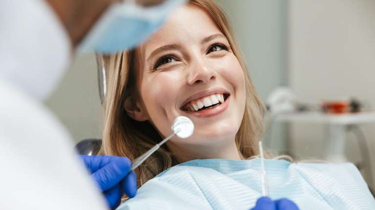Lady smiling after getting dental crowns at Neish Dentistry in in Beaverton.