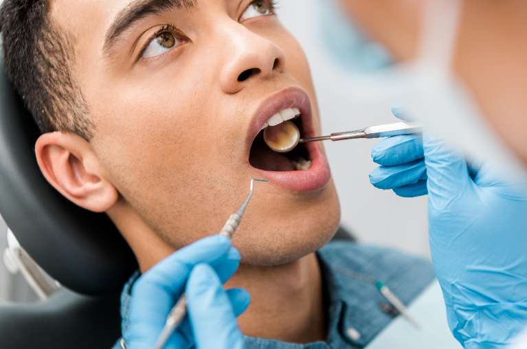patient receiving dental exam | tooth extraction beaverton or
