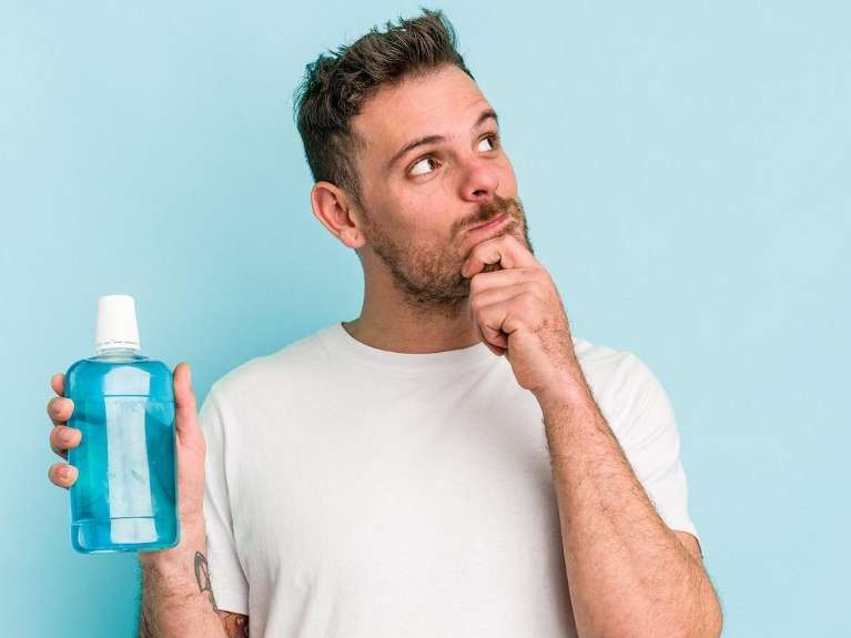 Patient holding a bottle with mouthwash | dental cleaning beaverton