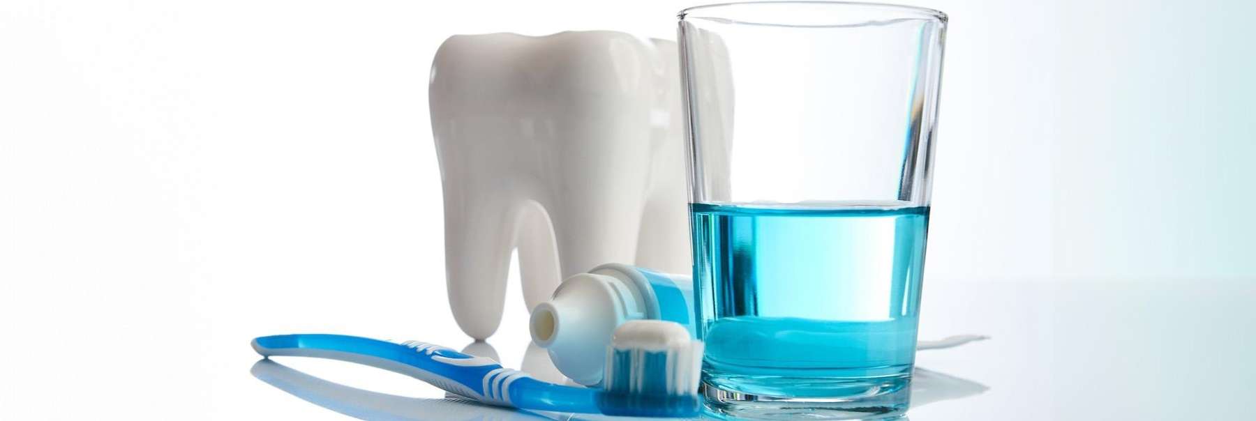 Model of a tooth, paste, brush and mouthwash | dentist beaverton