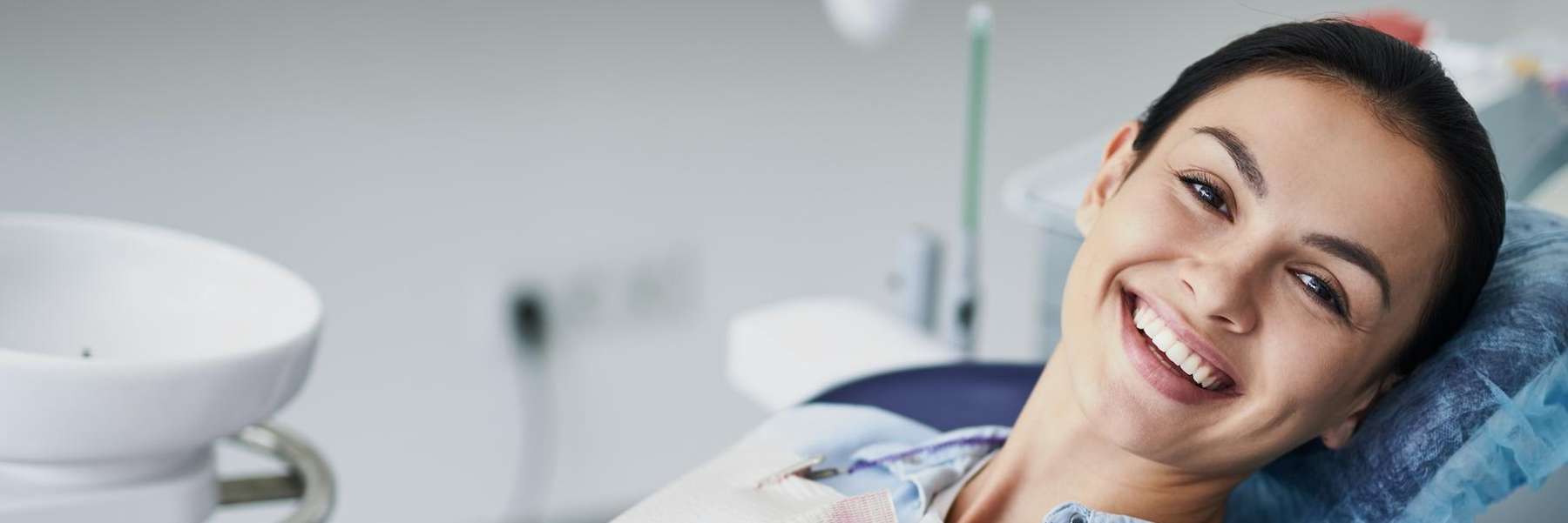 woman sitting in dentist exam chair | dentist beaverton or